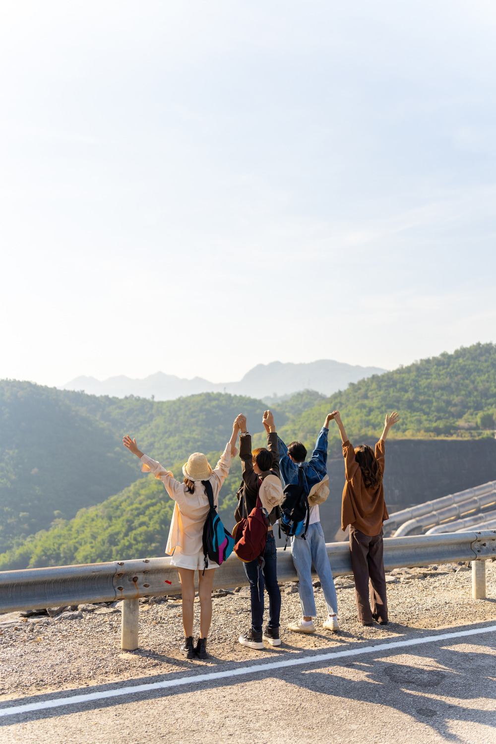 Group of people celebrating with raised arms overlooking mountains